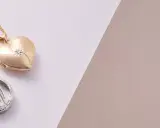 Złoty medalik w kształcie serca i srebrny z Matką Boską – idealne, gdy zastanawiasz się, kto kupuje medalik na chrzest.